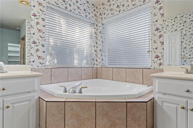 bathroom featuring vanity and a relaxing tiled tub