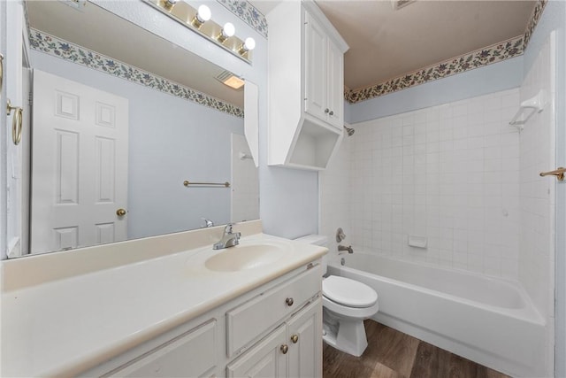 full bathroom featuring hardwood / wood-style floors, vanity, shower / bath combination, and toilet