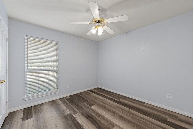 unfurnished room with dark hardwood / wood-style flooring and ceiling fan