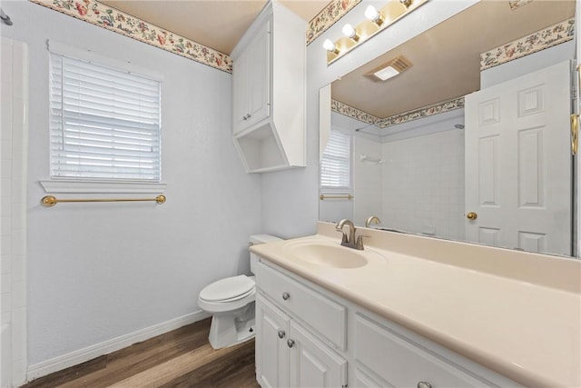 bathroom featuring wood-type flooring, vanity, and toilet