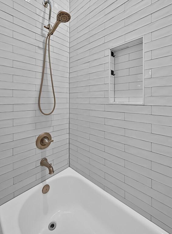 bathroom with tiled shower / bath combo