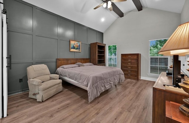 bedroom featuring ceiling fan, beamed ceiling, high vaulted ceiling, and light wood-type flooring