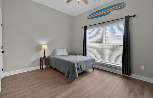 bedroom with hardwood / wood-style flooring and ceiling fan