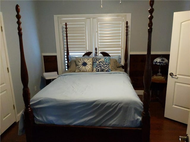 bedroom with dark hardwood / wood-style floors