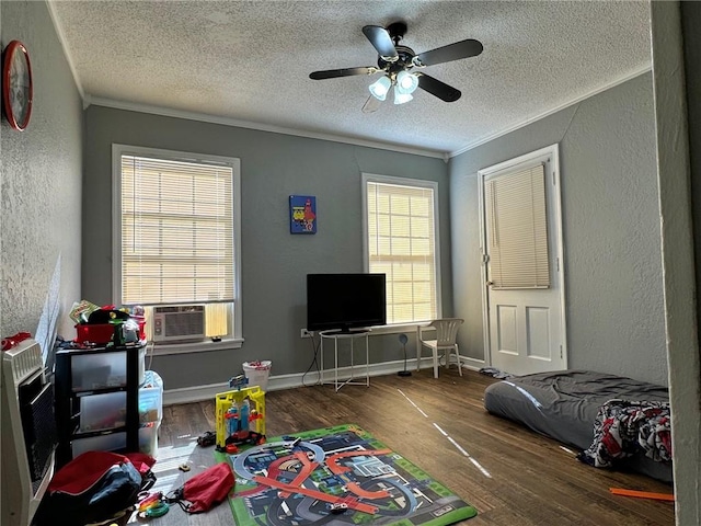 bedroom featuring a textured ceiling, dark hardwood / wood-style floors, ceiling fan, and ornamental molding