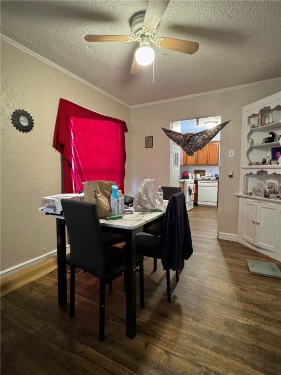 dining room with ceiling fan, wood-type flooring, a textured ceiling, and ornamental molding