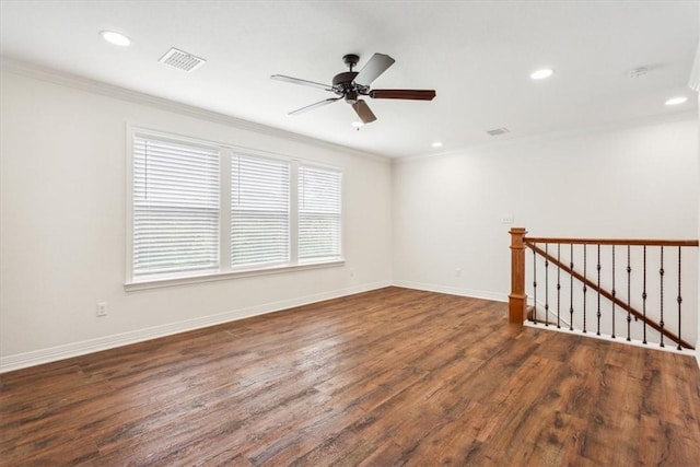 spare room featuring dark hardwood / wood-style floors, plenty of natural light, and ornamental molding