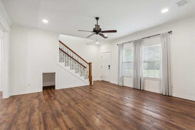 unfurnished living room with ceiling fan, crown molding, and dark wood-type flooring