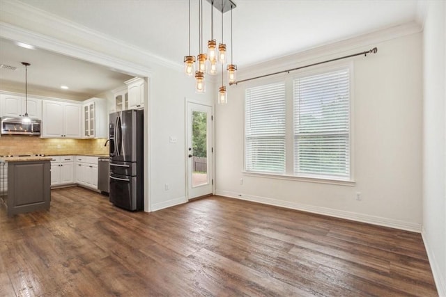 kitchen with dark hardwood / wood-style flooring, white cabinetry, pendant lighting, and stainless steel appliances