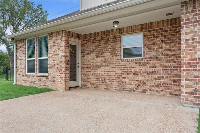 property entrance with a patio