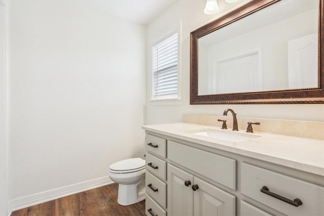 bathroom featuring vanity, hardwood / wood-style flooring, and toilet