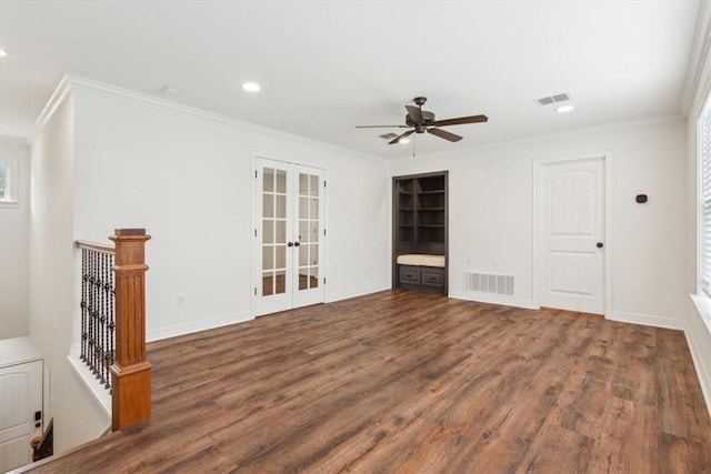 unfurnished living room with dark hardwood / wood-style flooring, ornamental molding, and french doors