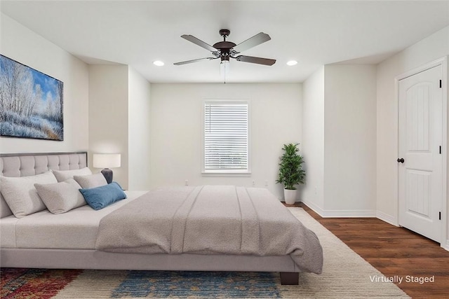 bedroom with dark hardwood / wood-style flooring and ceiling fan