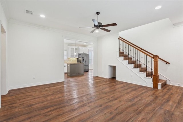 unfurnished living room featuring ceiling fan, dark hardwood / wood-style floors, and ornamental molding