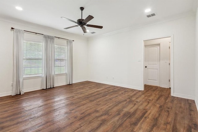 empty room with ceiling fan, dark hardwood / wood-style flooring, and crown molding