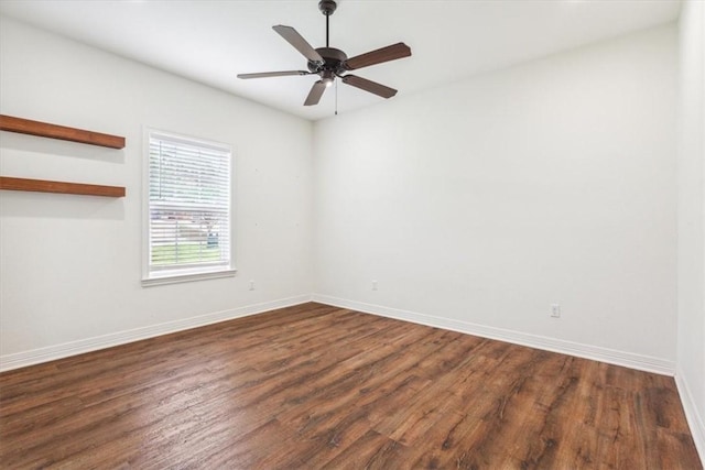 spare room with dark hardwood / wood-style floors and ceiling fan