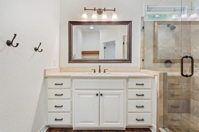 bathroom featuring hardwood / wood-style floors, vanity, and a shower with shower door