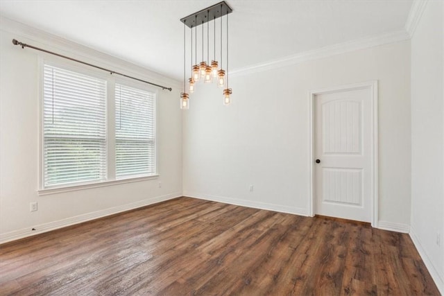 empty room featuring dark hardwood / wood-style floors and crown molding