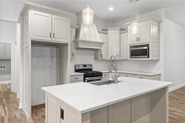 kitchen with premium range hood, decorative backsplash, pendant lighting, and appliances with stainless steel finishes