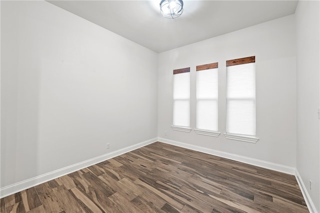 unfurnished room with dark hardwood / wood-style floors