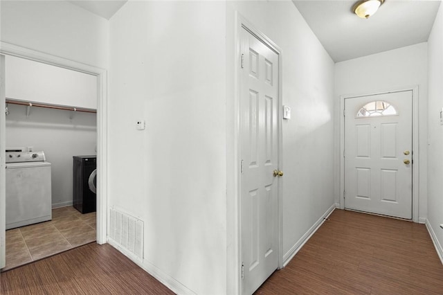 interior space with washer and dryer and dark wood-type flooring