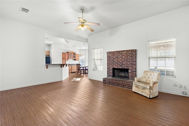 unfurnished living room featuring a wealth of natural light, dark hardwood / wood-style flooring, and ceiling fan