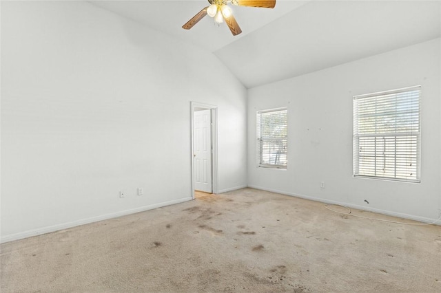 empty room with light colored carpet, ceiling fan, and lofted ceiling