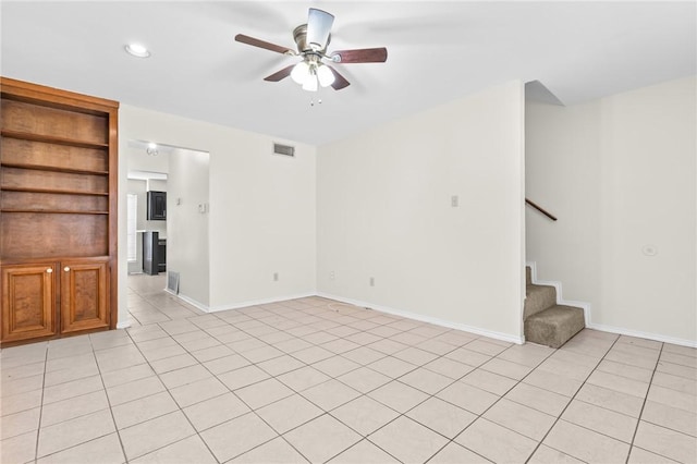 unfurnished living room with ceiling fan and light tile patterned flooring