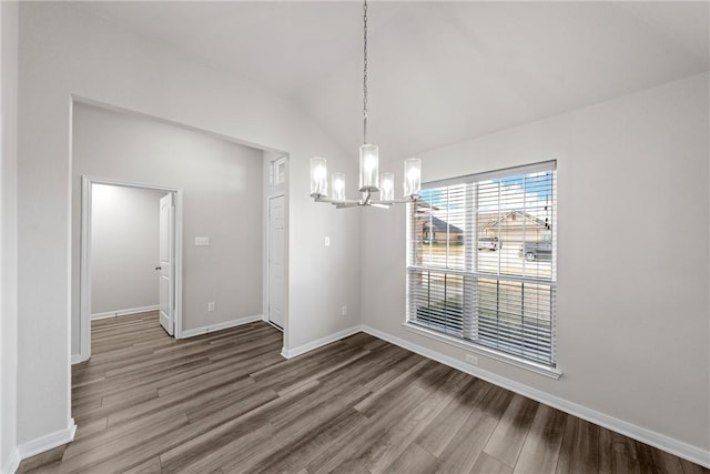 unfurnished dining area featuring hardwood / wood-style floors, lofted ceiling, and a notable chandelier