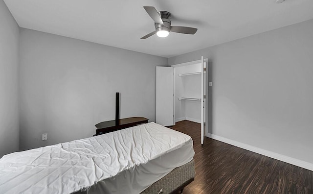 bedroom featuring baseboards, dark wood-type flooring, and ceiling fan