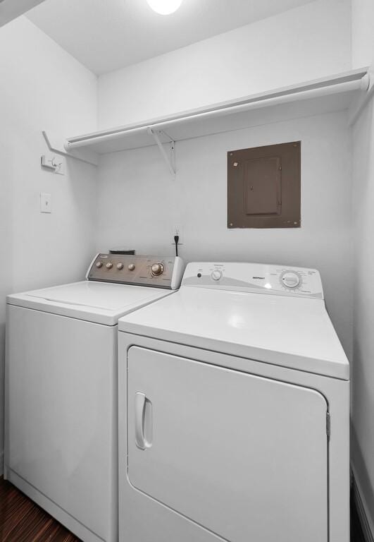 laundry area with washer and dryer, laundry area, electric panel, and dark wood finished floors