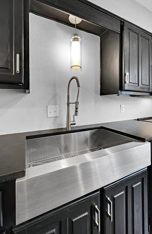 details with dark cabinetry and a sink