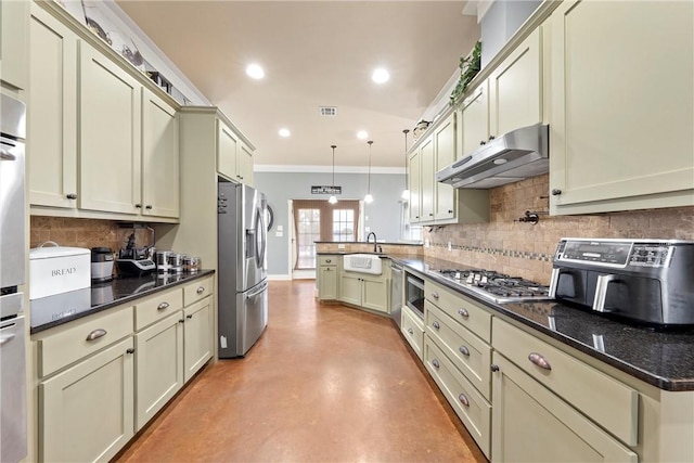 kitchen with kitchen peninsula, appliances with stainless steel finishes, dark stone counters, crown molding, and hanging light fixtures