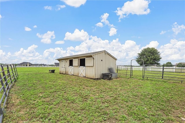 view of outbuilding with a yard and a rural view