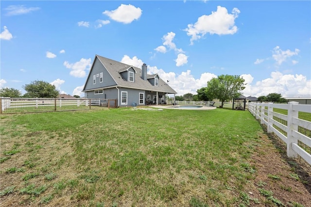 view of yard with a fenced in pool and a patio