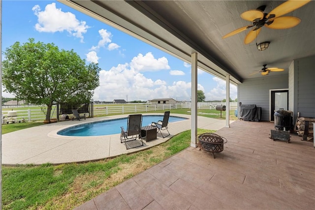 view of pool featuring a patio area and a fire pit