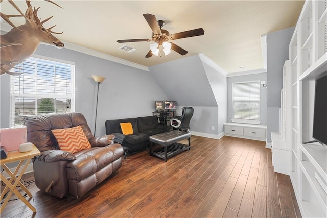 living room featuring dark hardwood / wood-style floors, a healthy amount of sunlight, lofted ceiling, and ornamental molding