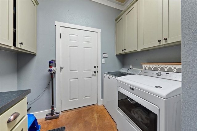 laundry area featuring separate washer and dryer and cabinets