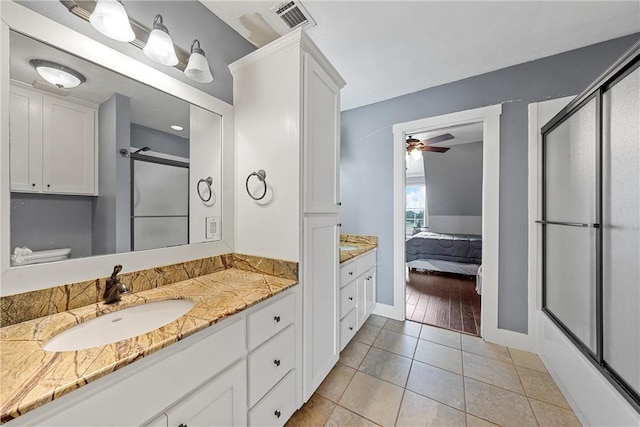 bathroom with tile patterned floors, ceiling fan, toilet, and vanity