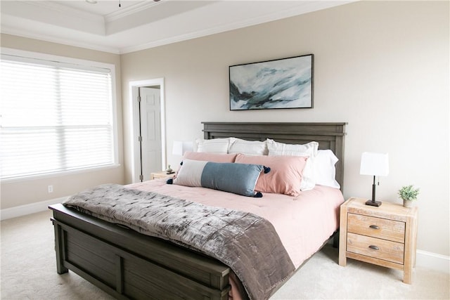 bedroom featuring crown molding, baseboards, a raised ceiling, and light colored carpet