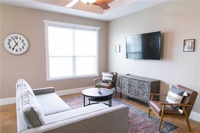 living room featuring ceiling fan and baseboards