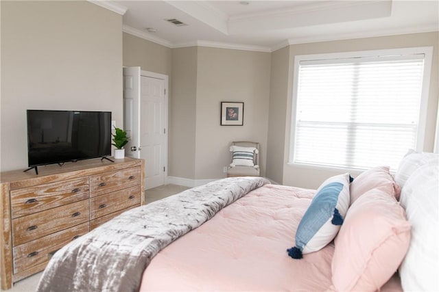 bedroom with light carpet, baseboards, visible vents, a raised ceiling, and crown molding