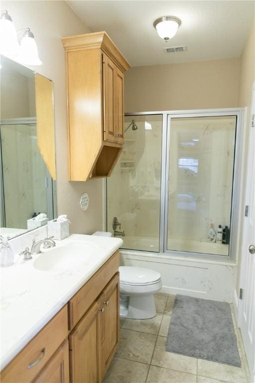 full bath with visible vents, toilet, enclosed tub / shower combo, vanity, and tile patterned floors