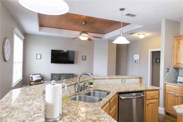 kitchen with a sink, backsplash, a raised ceiling, and dishwasher