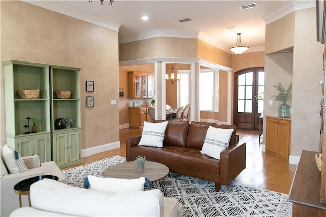 living room with arched walkways, visible vents, crown molding, and an inviting chandelier