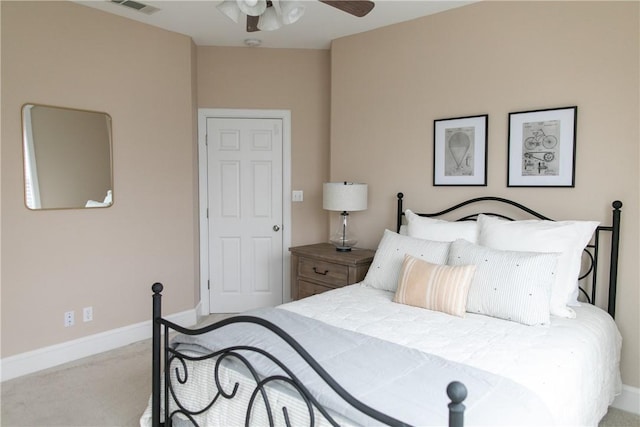 carpeted bedroom with a ceiling fan and baseboards