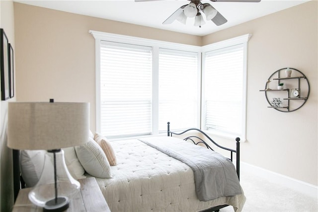 bedroom with carpet floors, ceiling fan, and baseboards