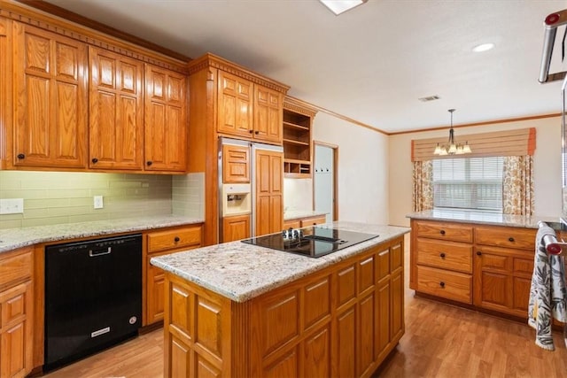 kitchen featuring pendant lighting, an inviting chandelier, black appliances, light hardwood / wood-style flooring, and a kitchen island