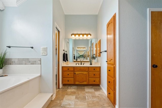 bathroom with a bath, vanity, and ornamental molding