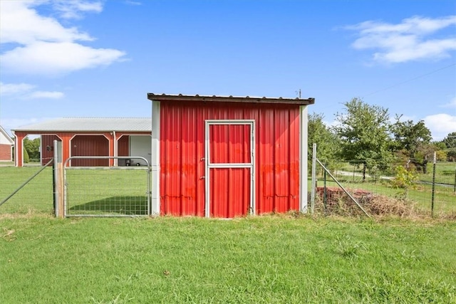 view of outbuilding with a yard